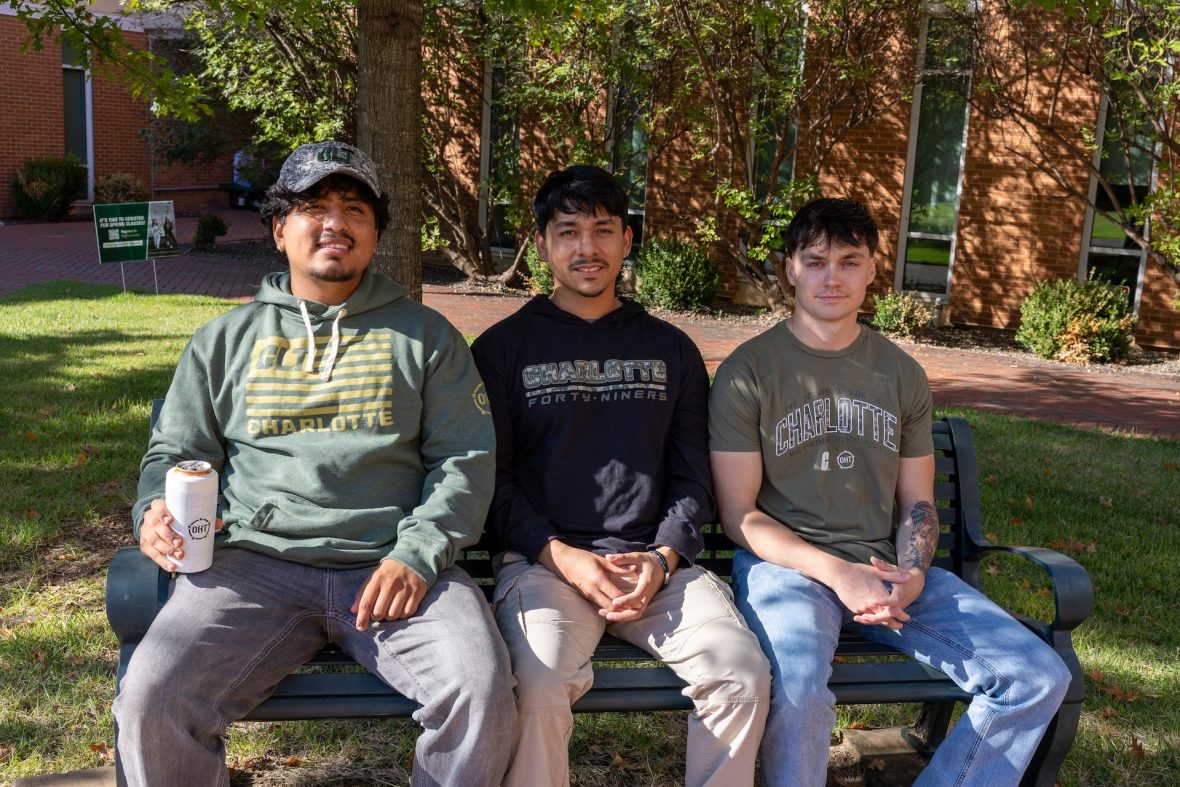 Veterans and current UNC Charlotte students pose with OHT gear.