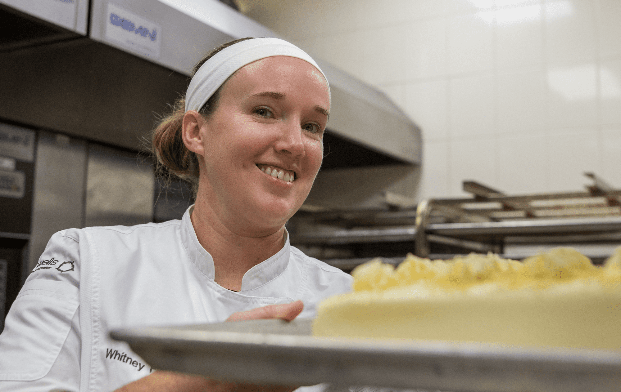 Photo of Chef Whitney Dupree holding cake