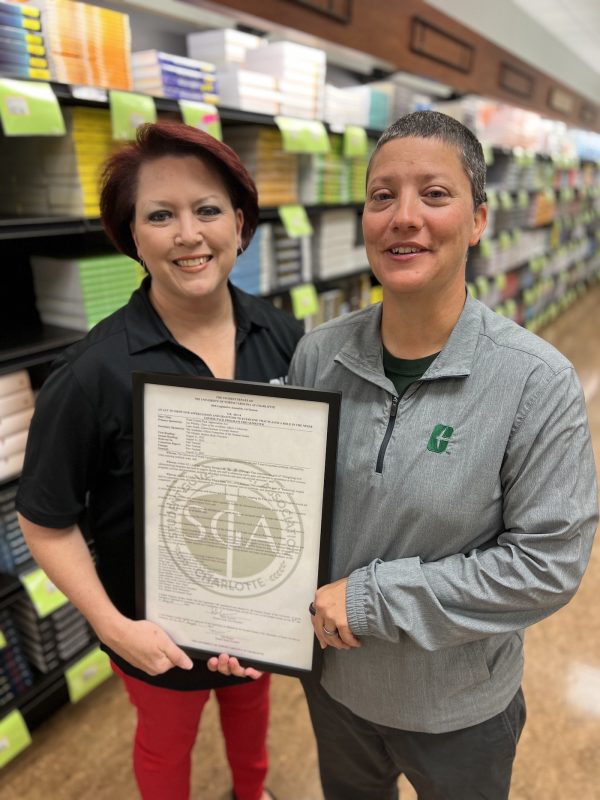 Rachel Skipworth and Cheri Griffith smile with honorary resolution