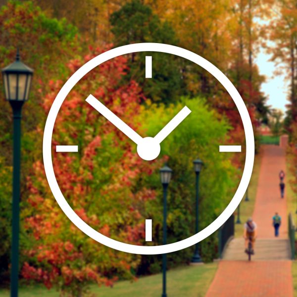 clock icon and charlotte campus in fall