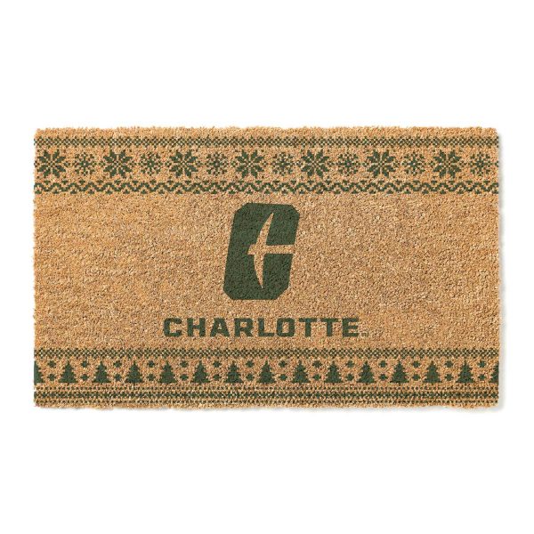 Doormat with green snowflake and Christmas tree patterns and a Charlotte logo in the center
