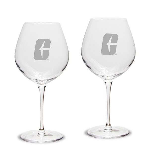 Two wine glasses with All-in-C Charlotte logo engraved on the side