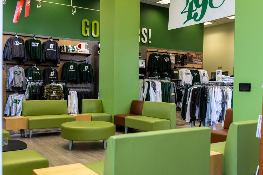 Light green chairs arranged to face each other with Niner Gear and green pillars in the background.