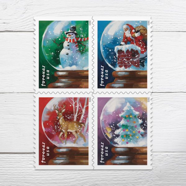 four stamps with winter themed snow globe designs