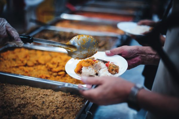 Photograph of someone being served a hot meal