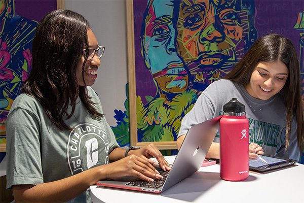 student types on a laptop