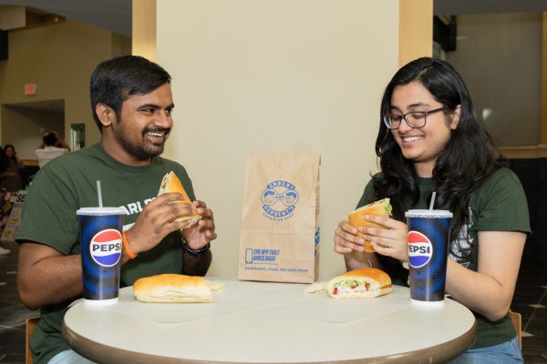 Two students enjoying their meals.