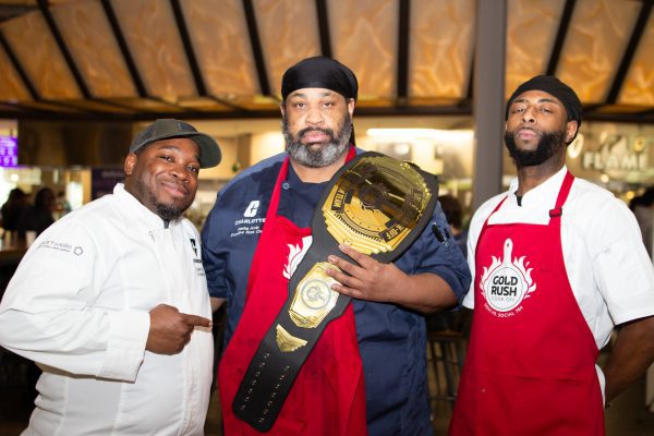 chefs pose with championship belt at the 2025 Gold Rush Cook Off